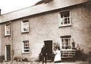 John & Lydia Braund (nee Saunders) outside their Bucks Mills Cottage circa 1910